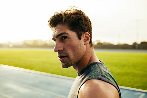 Sprinter standing on running track