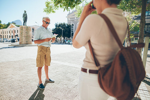 Senior couple taking photos on their vacation