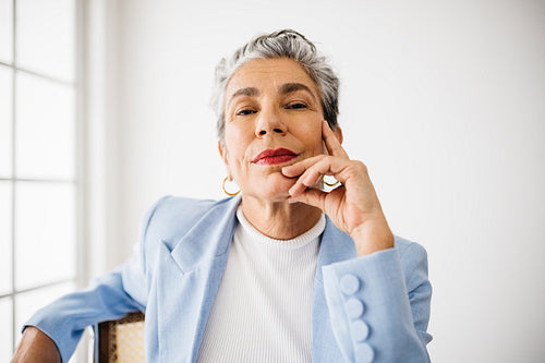 Mature and empowered business woman looking at the camera in an office