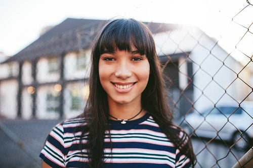 Hispanic woman looking at camera and smiling