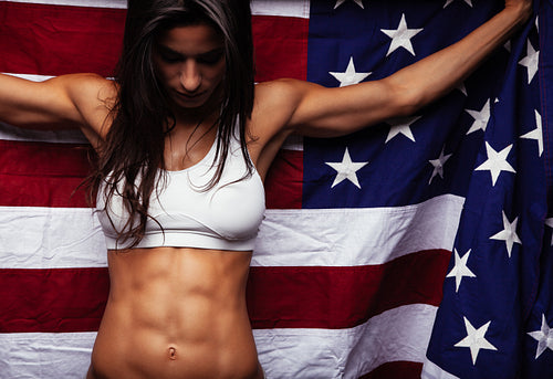 Female athlete holding American flag