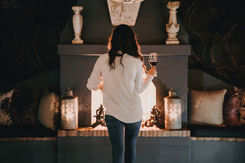 Young woman holding a wineglass in a luxury hotel
