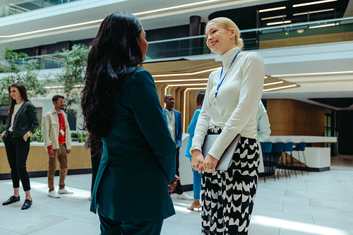 Female professionals engaging in a wealth management discussion in a high-end office space