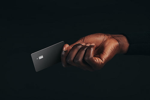 Going cashless with premium benefits, man uses his black credit card to make a payment