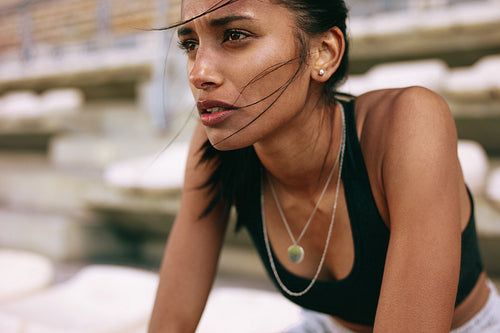 Sportswoman taking rest after training session at stadium