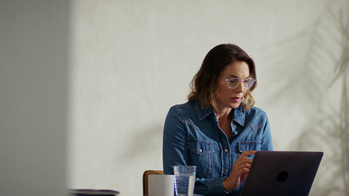 Business professional working on laptop at her office desk