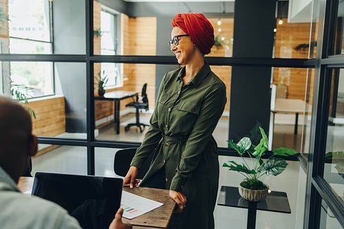 Happy Muslim businesswoman having a meeting with her colleagues