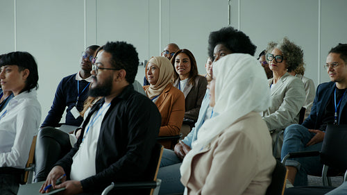 Diverse group of professionals actively listening and learning during a seminar