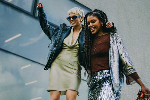 Young friends walk laughing together in the city