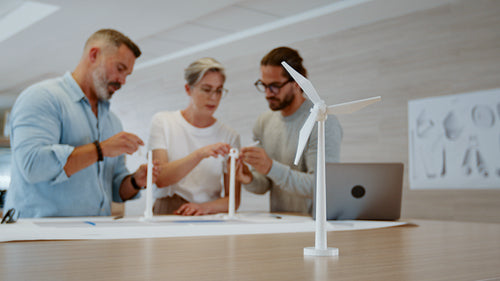 Group of engineers collaborating on an industrial design for wind turbines