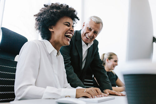 Happy business people working together in office.