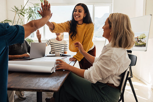 Architect team celebrating a success while working together in their office