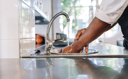 Chef washing his hands in commercial kitchen