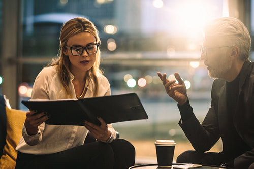 Business colleagues working in office lobby