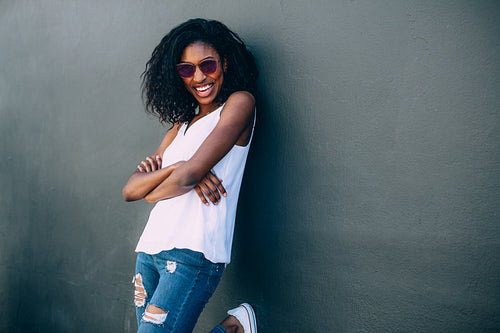 Portrait of a woman standing against a wall