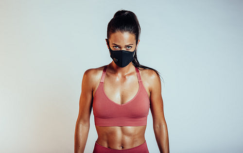 Woman with muscular build in face mask