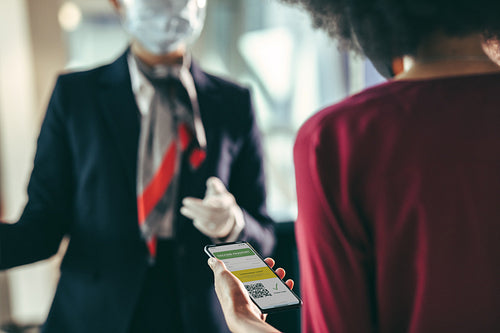 Woman passenger checking in at airport with her immunity passpor
