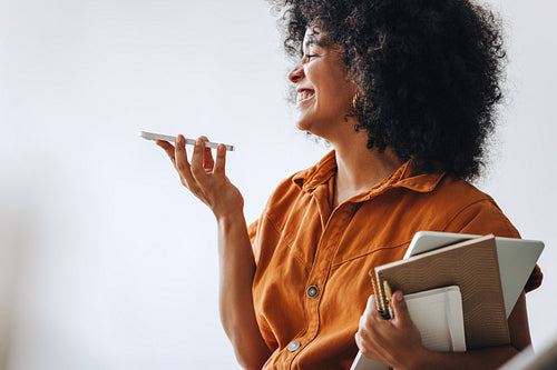 Cheerful businesswoman smiling while taking a phone call