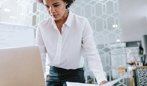 Businesswoman working on laptop in modern office