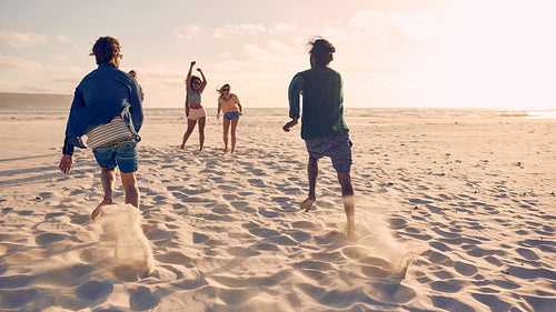 Friends running a race on the beach