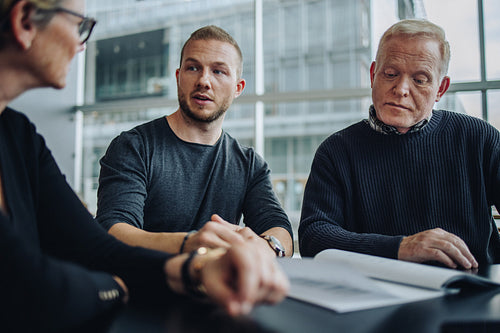 Business people discussing over a contract in meeting