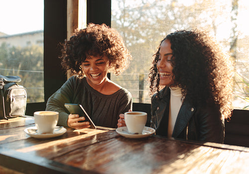 Two women having fun at a coffee shop