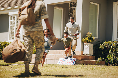 Soldier being welcomed by her family at home