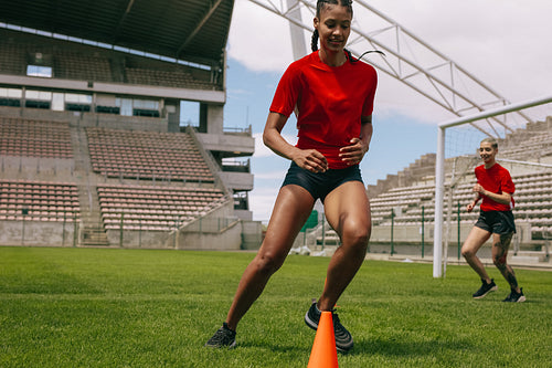 Woman training on football field