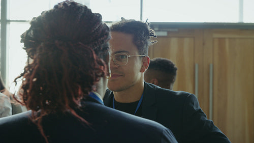 Business professionals having an engaging conversation during a conference networking event