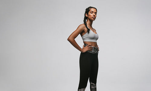 Fit woman standing against white background