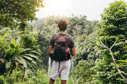 Male hiker admiring the waterfall