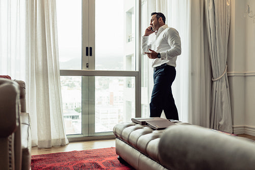 Businessman making phone call from hotel room