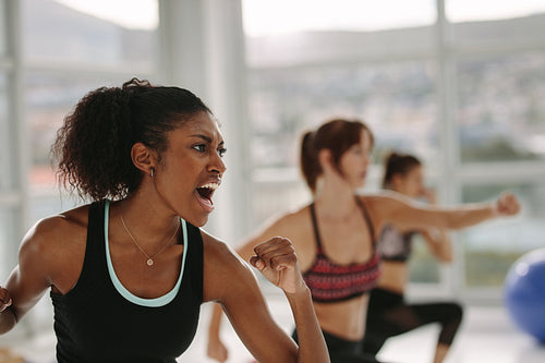 Group of people in gym class having punch training