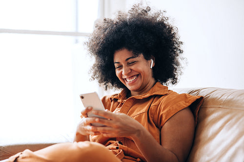 Cheerful young businesswoman having a video call on a smartphone