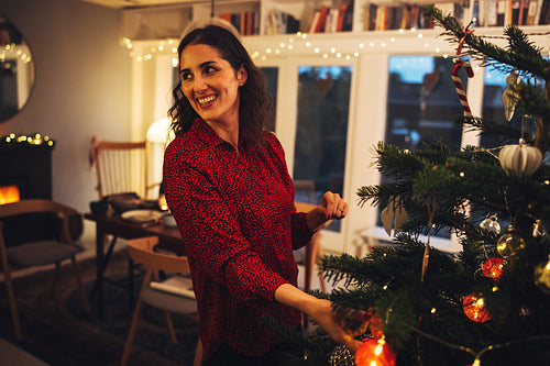 Woman decorating Christmas tree