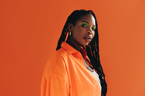 Black woman with makeup standing in a studio