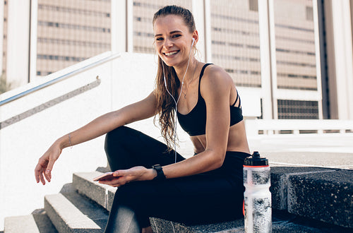 Sports woman relaxing after working out outdoors