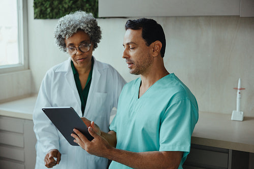 Dental professionals use tablet for patient consultation in clinic