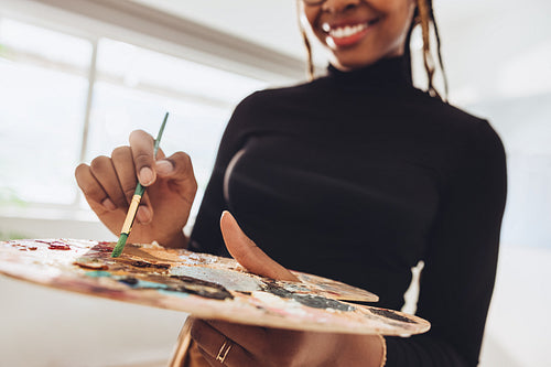 Artist holding a brush and a palette