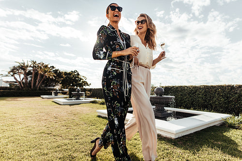 Stylish female friends walking together