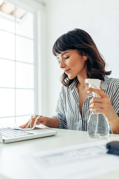 Close up of businesswoman cleaning her laptop
