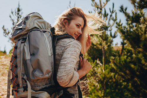 Woman with backpack hiking in nature