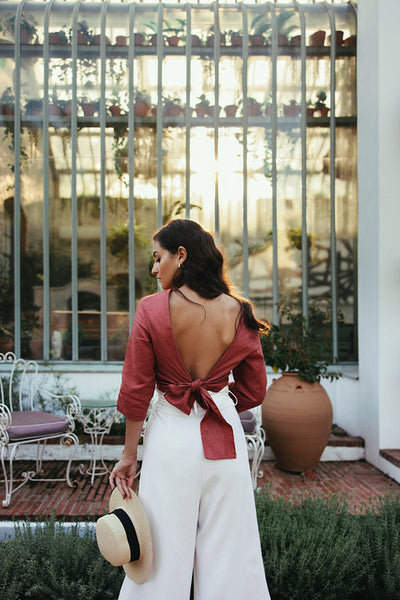 Attractive young woman standing in front of a hotel