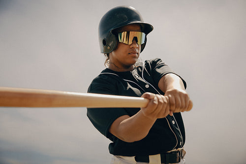 Professional baseball player poised at the plate, hitting a bunt shot
