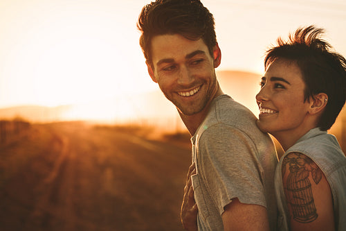 Woman embracing a man outdoors on a road trip