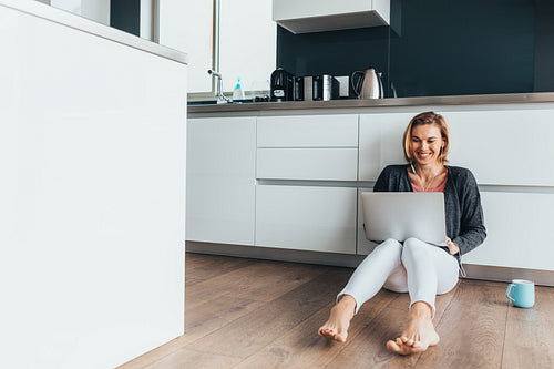 Woman video calling over laptop computer