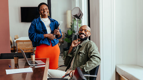Co-workers enjoying a relaxed and modern office environment with smiles and positive energy