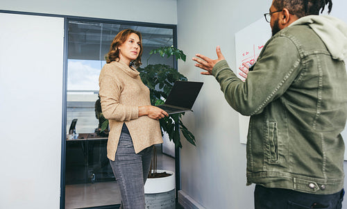 Business professionals collaborating on ideas and strategy in an office meeting
