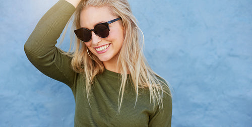 Cheerful young female model with sunglasses