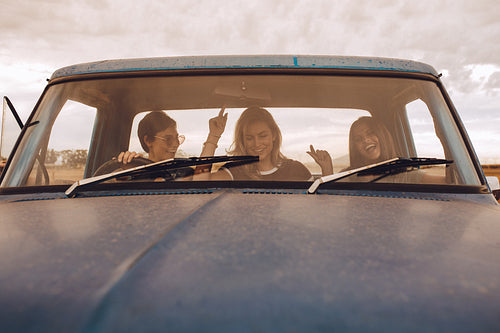 Group of females having fun traveling in a truck